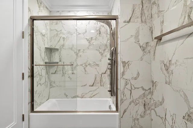 a bathroom with a bathtub and shower