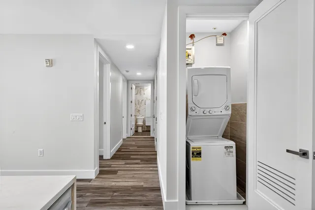 a view of a hallway with wooden floor and entryway