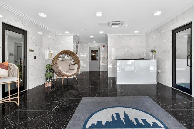 a open kitchen with stainless steel appliances granite countertop a stove a refrigerator and a dining table with wooden cabinet