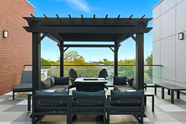 a view of a balcony with chairs and a potted plant