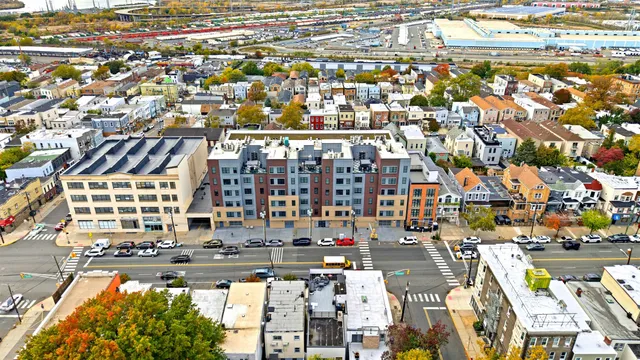 an aerial view of residential building with parking and space