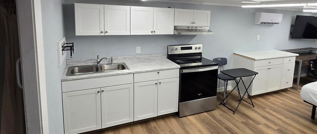 121 Arrowhead Quitman, TX 75783 - Photo 12 of 20 a kitchen with granite countertop a sink cabinets and stainless steel appliances