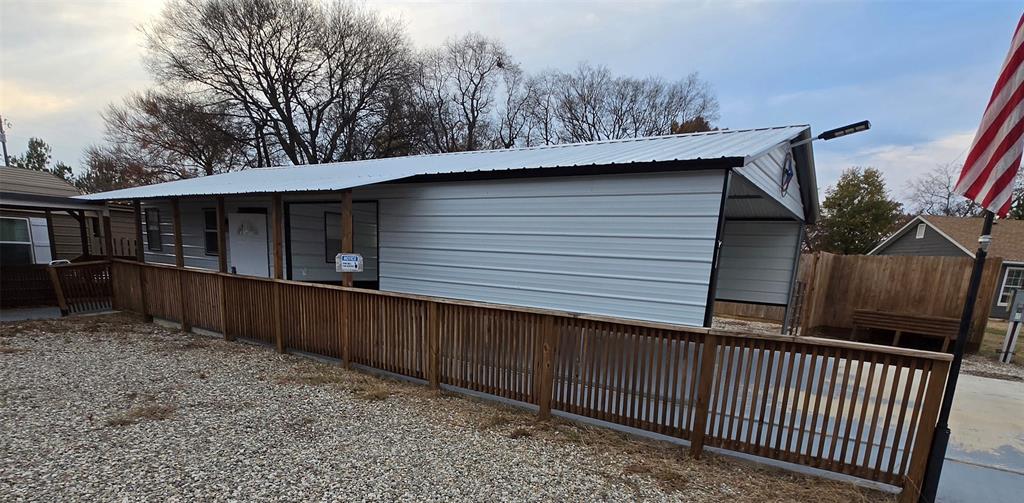 121 Arrowhead Quitman, TX 75783 - Photo 3 of 13 a side view of a house with a wooden fence