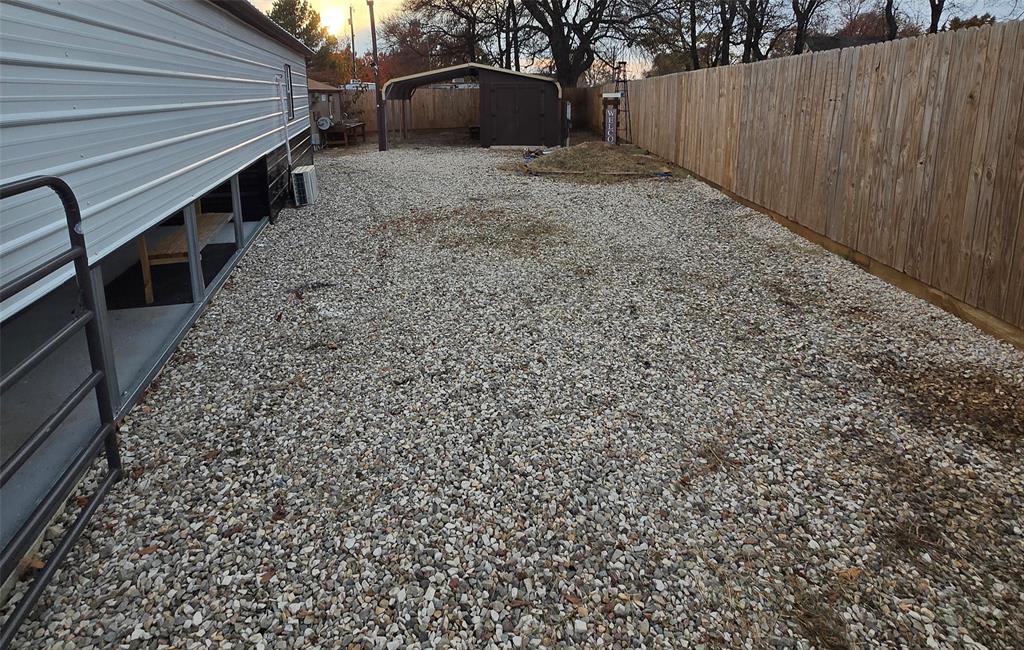 121 Arrowhead Quitman, TX 75783 - Photo 7 of 20 a view of a backyard with pathway