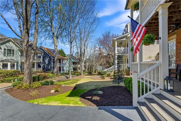a kitchen with stainless steel appliances a sink a stove a refrigerator cabinets and wooden floor