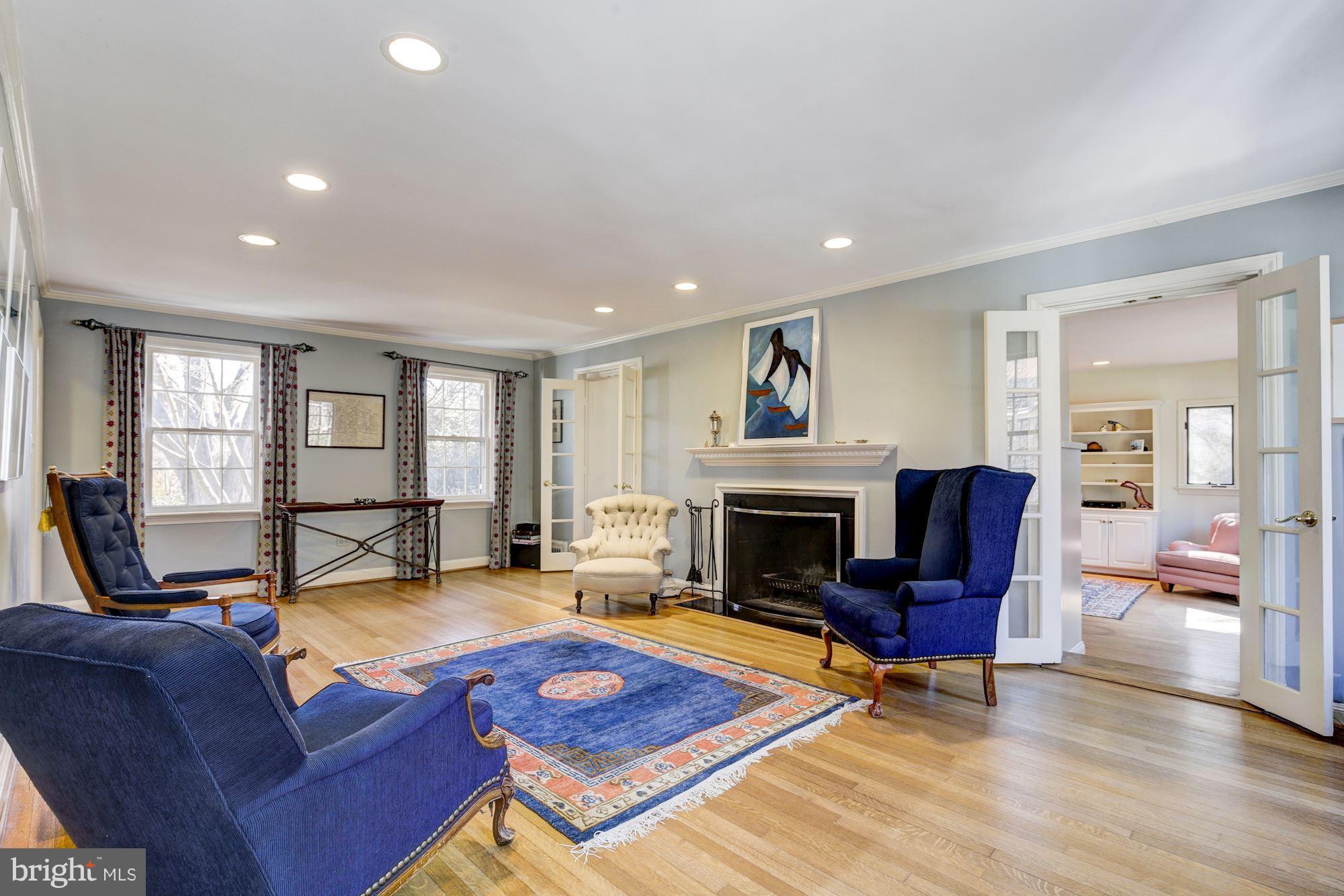6800 Glenbrook Road Bethesda, MD 20814 - Photo 12 of 30 a living room with furniture a fireplace and wooden floor