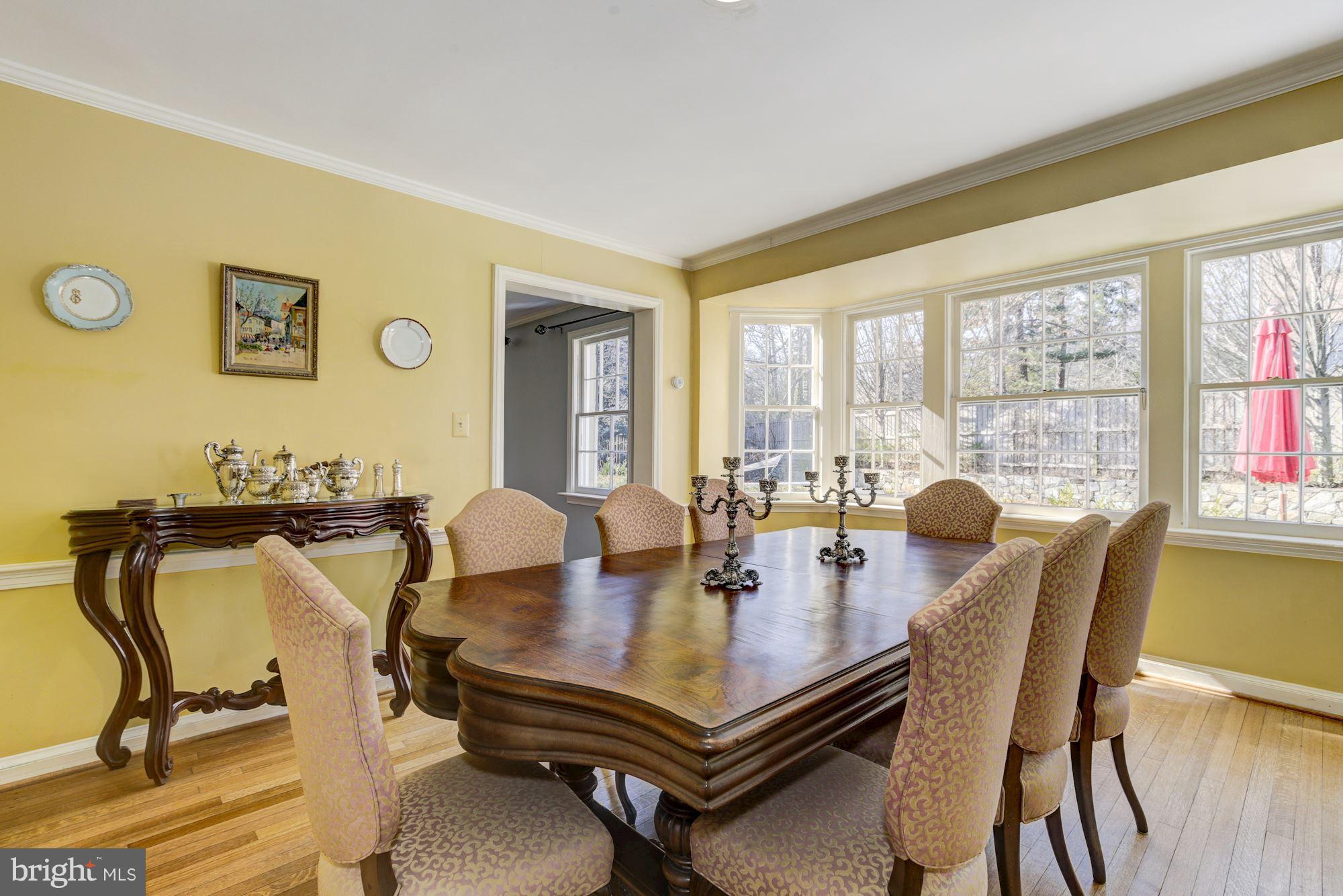 6800 Glenbrook Road Bethesda, MD 20814 - Photo 15 of 30 a view of a dining room with furniture and window