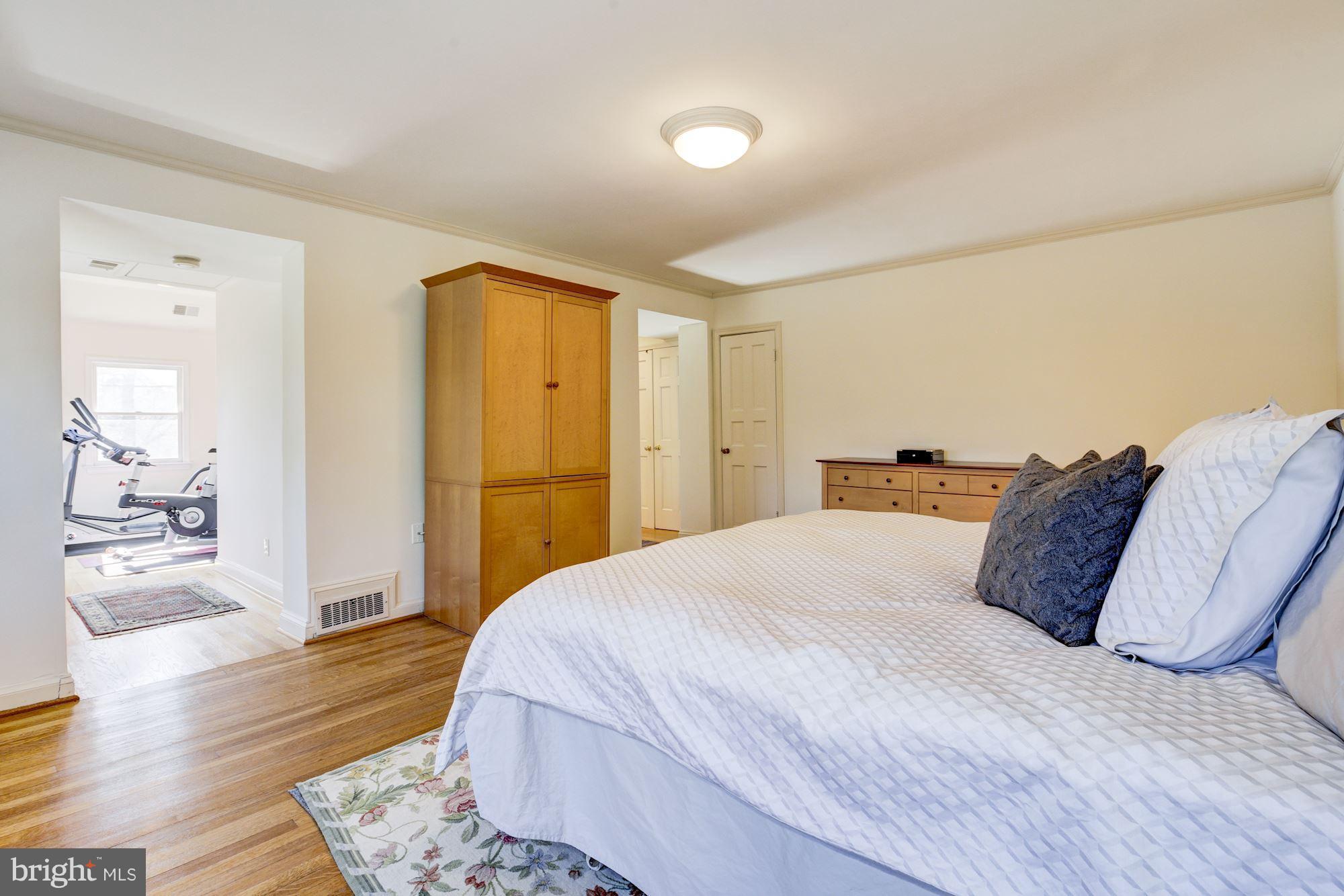6800 Glenbrook Road Bethesda, MD 20814 - Photo 20 of 30 a bedroom with a bed and wooden floor