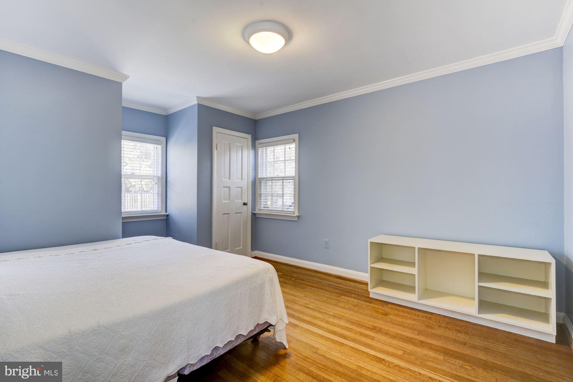 6800 Glenbrook Road Bethesda, MD 20814 - Photo 23 of 30 a bedroom with a bed and wooden floor