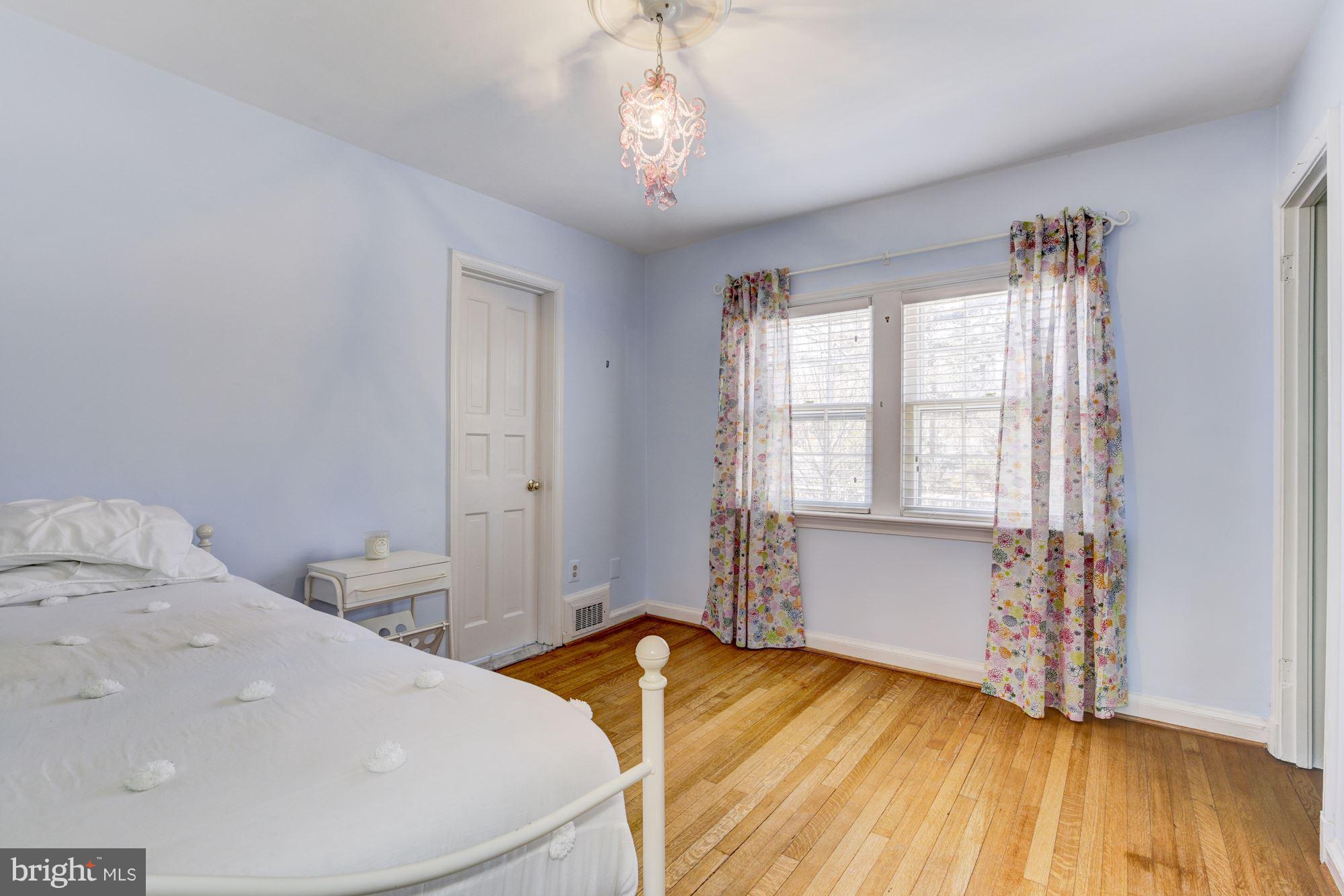 6800 Glenbrook Road Bethesda, MD 20814 - Photo 24 of 30 a spacious bedroom with a bed and wooden floor