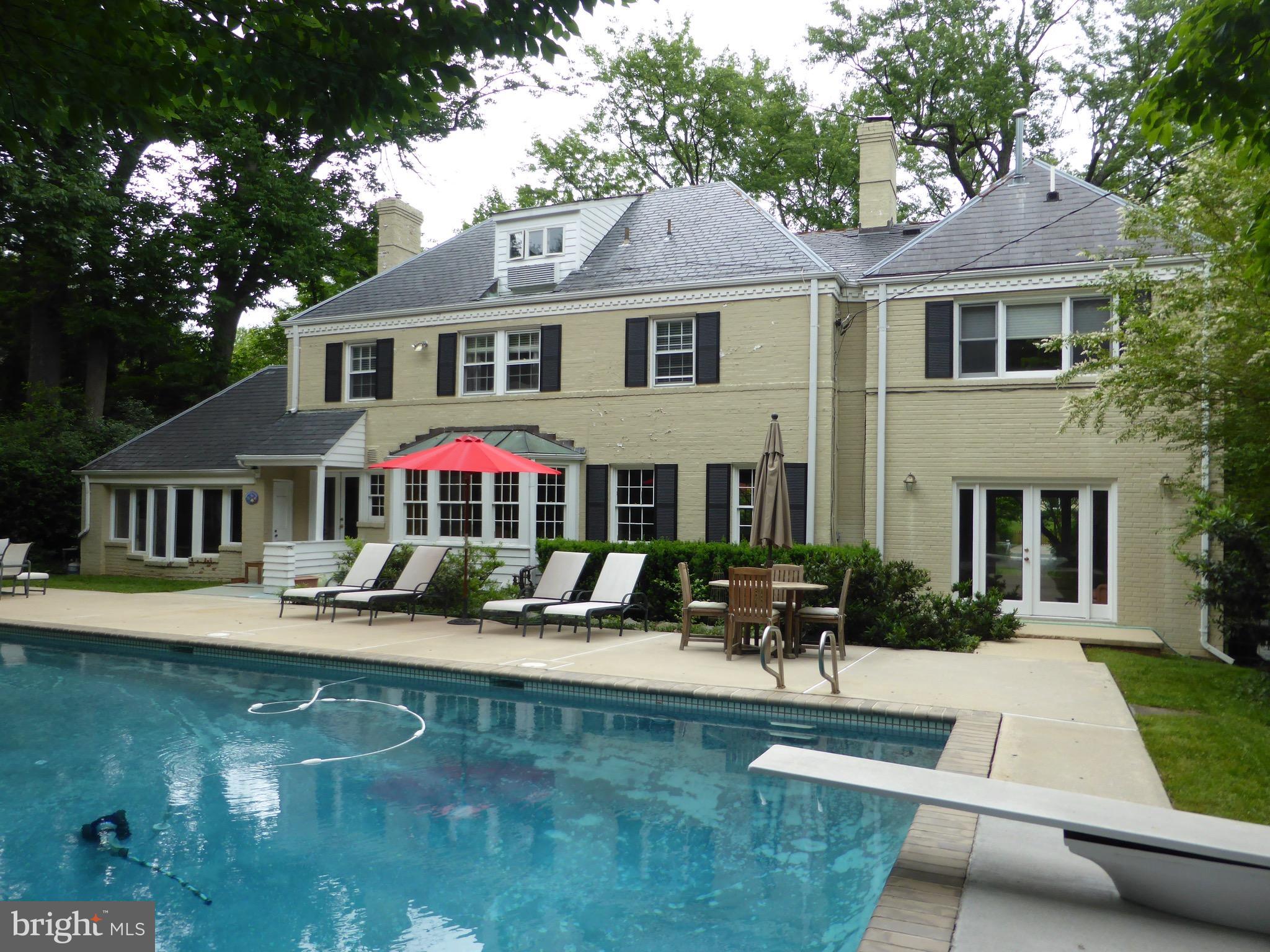 6800 Glenbrook Road Bethesda, MD 20814 - Photo 8 of 30 a front view of a house with yard porch and sitting area