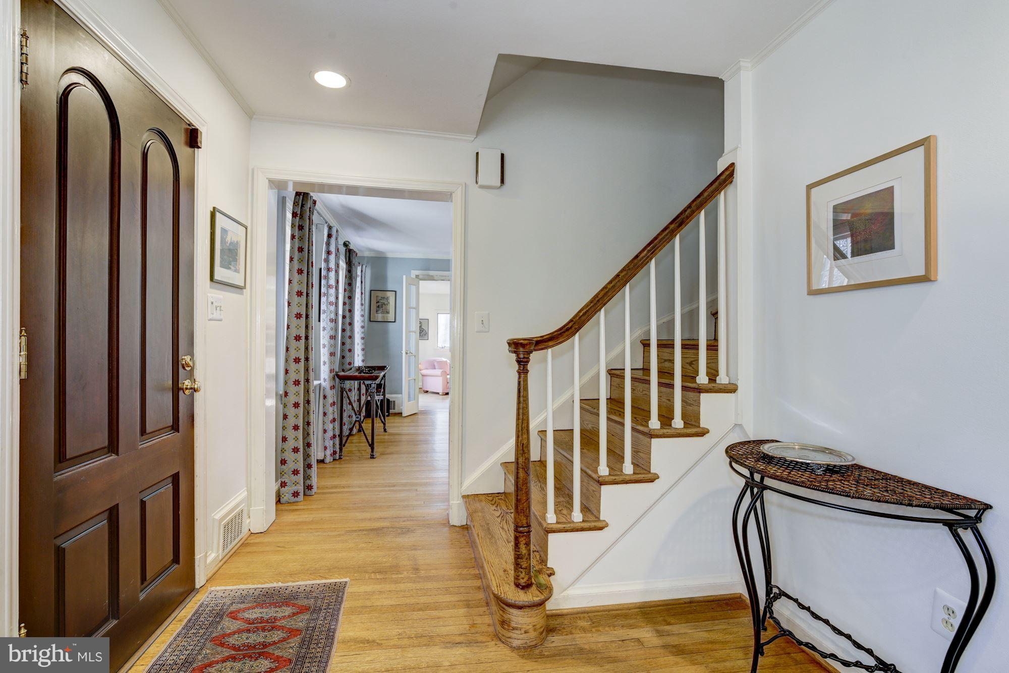 6800 Glenbrook Road Bethesda, MD 20814 - Photo 10 of 30 a view of a hallway with wooden floor and staircase