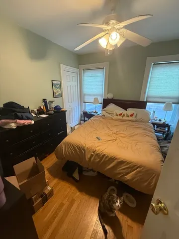 a bed sitting in a bedroom next to a window