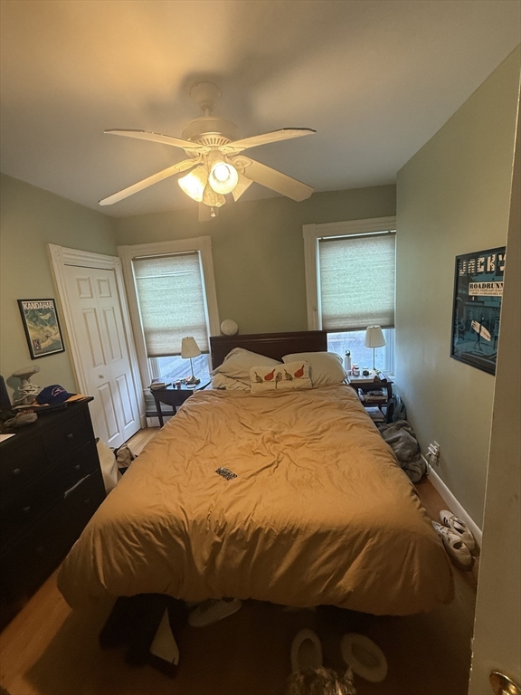 60 Walden Street, Unit 3 Cambridge, MA 02140 - Photo 4 of 12 a bedroom with a bed and a mirror