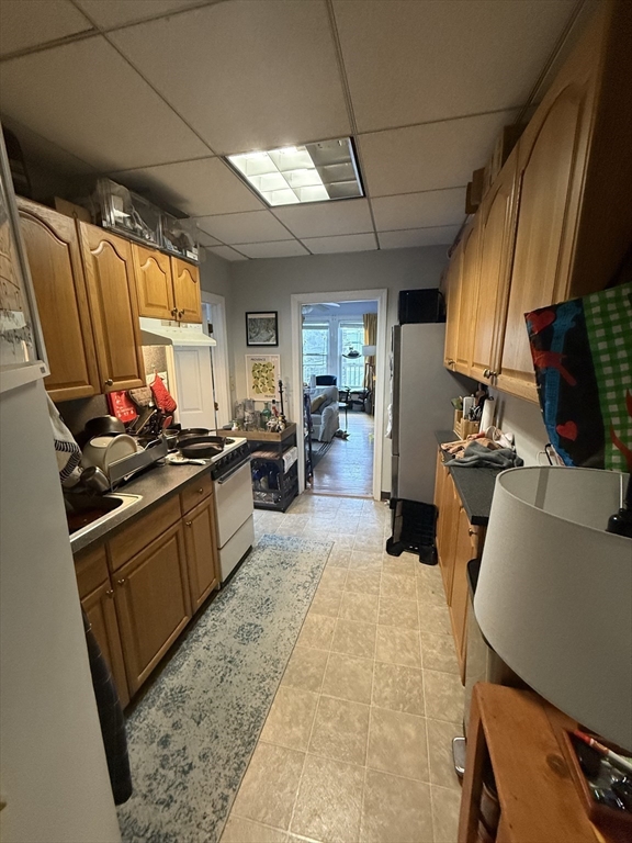 60 Walden Street, Unit 3 Cambridge, MA 02140 - Photo 6 of 12 a kitchen with sink refrigerator and microwave