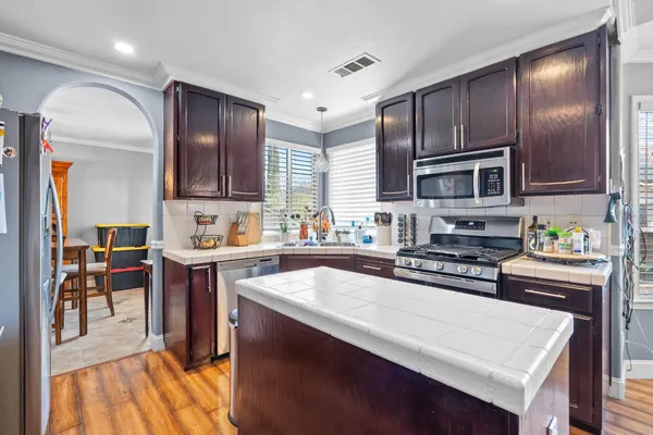 a kitchen with a stove a sink and cabinets
