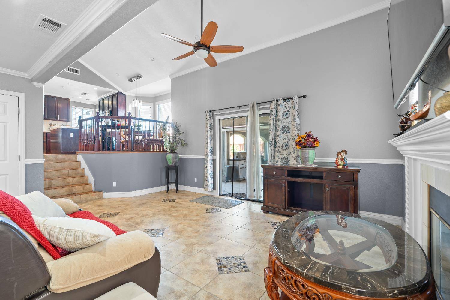 446 Port Street Los Banos, CA 93635 - Photo 20 of 55 Spacious Family Room with Ceiling Fan, Crown Molding, Canister Lighting, Tile Flooring, Custom Baseboards, Fireplace and Natural Lighting.
