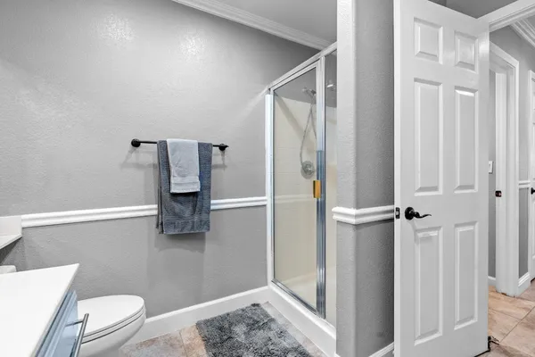 a view of a room with wooden floor and bathroom