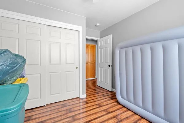 a view of a hallway with wooden floor and furniture