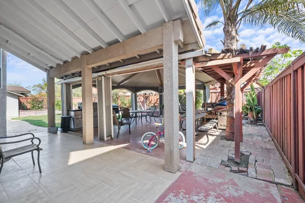 a view of a house with backyard porch and sitting area