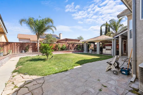a view of a house with swimming pool and a yard