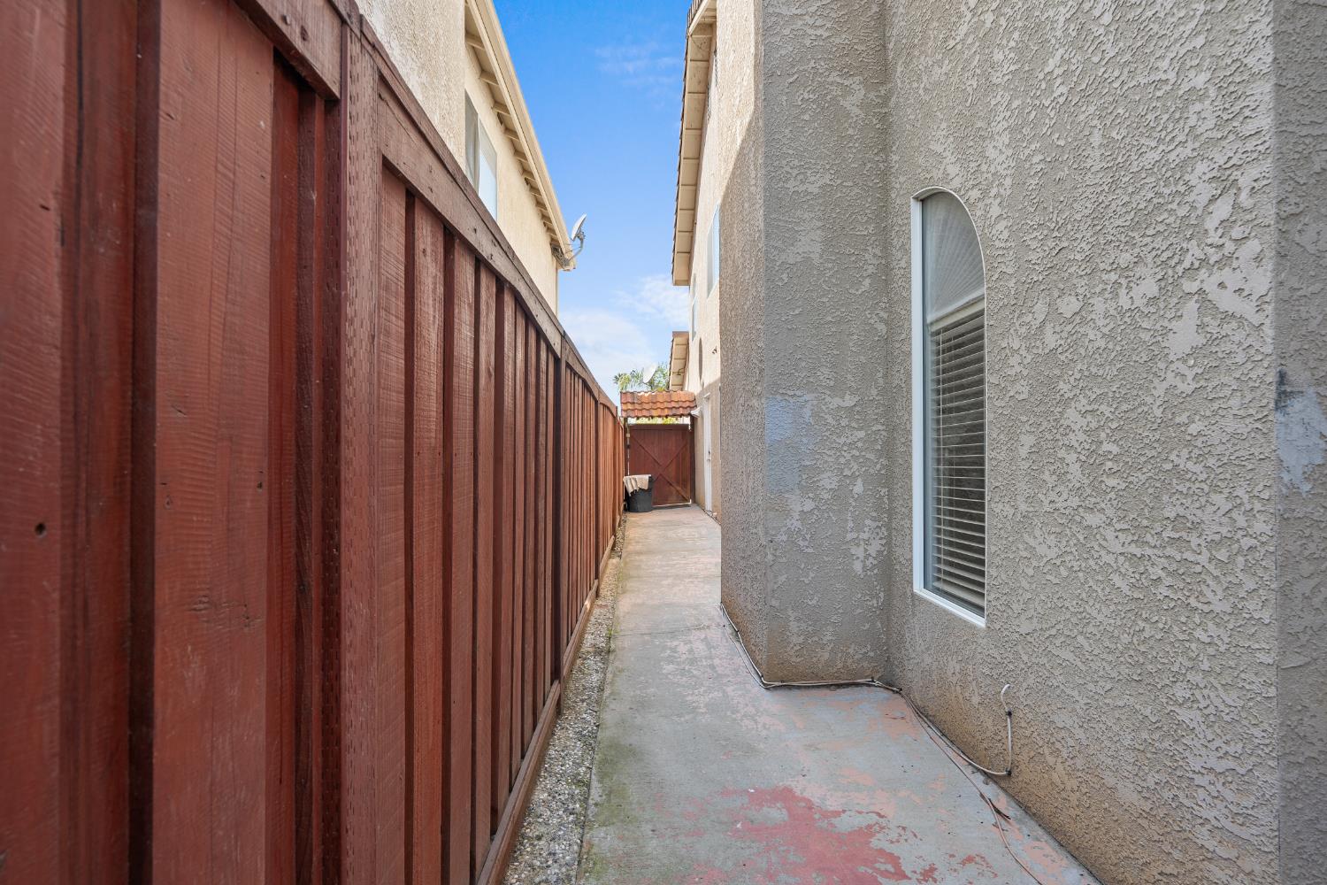 446 Port Street Los Banos, CA 93635 - Photo 54 of 55 Concrete Side Yard Walkway Makes for Low Maintenance Living.