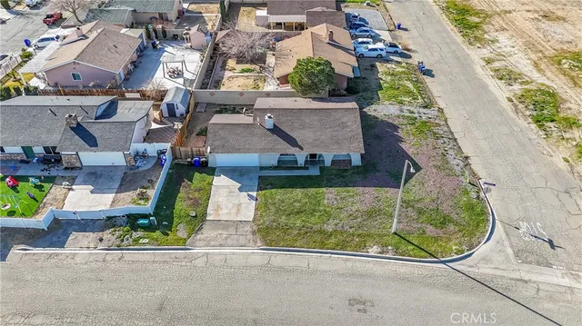 an aerial view of a house with garden space and street view