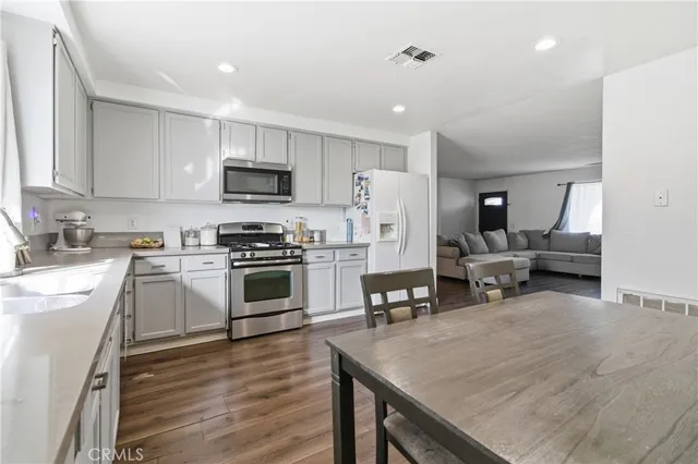 a kitchen with a stove a sink and a refrigerator