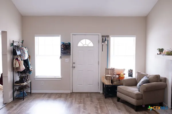 a view of an entryway with wooden floor