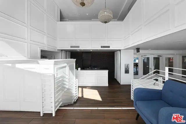 a living room with furniture and kitchen view
