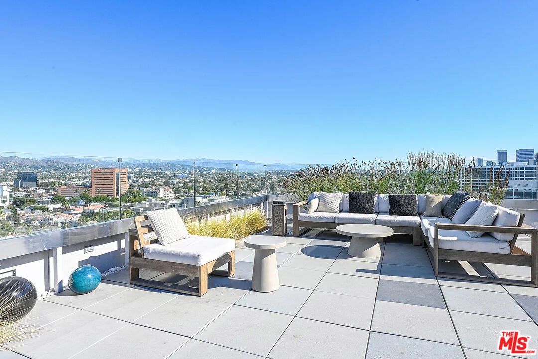 8601 Wilshire Boulevard, Unit 701 Beverly Hills, CA 90211 - Photo 2 of 14 a terrace with outdoor seating city view and barbeque oven