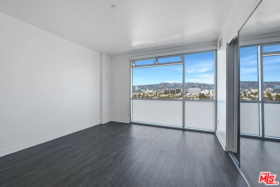 8601 Wilshire Boulevard, Unit 701 Beverly Hills, CA 90211 - Photo 5 of 14 a view of a room with wooden floor and window