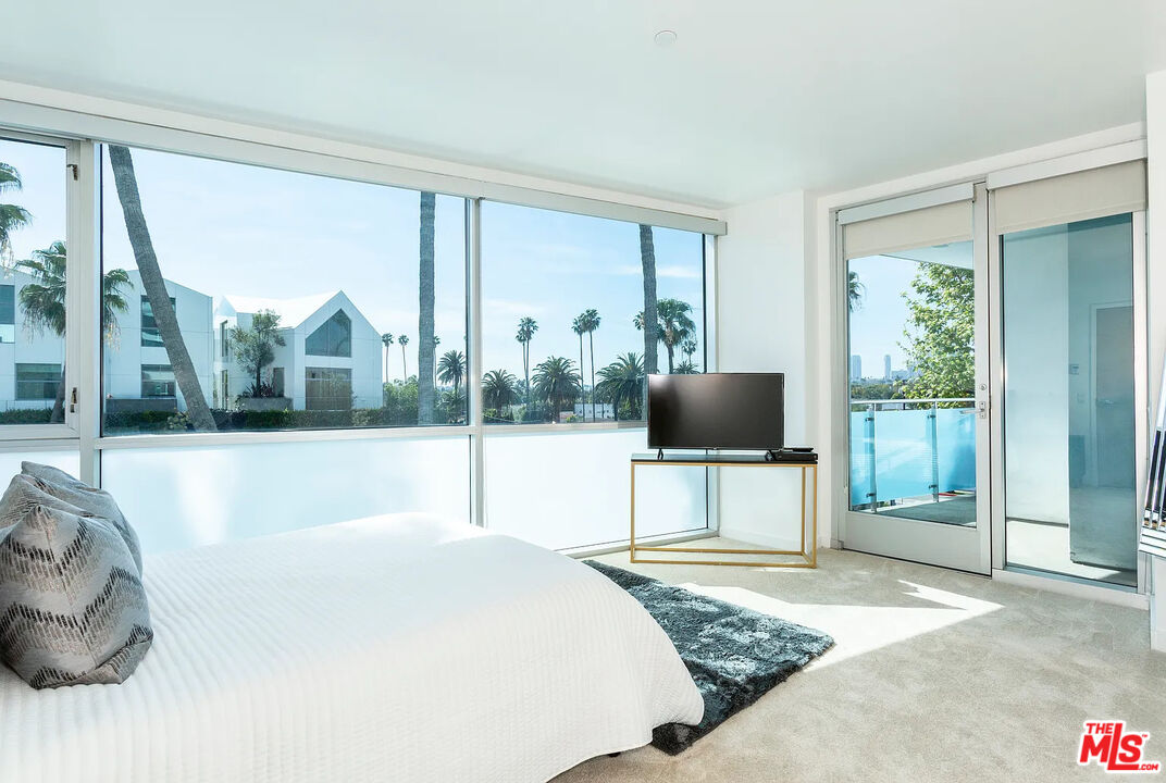 8601 Wilshire Boulevard, Unit 701 Beverly Hills, CA 90211 - Photo 6 of 14 a living room with a large window and a floor to ceiling window