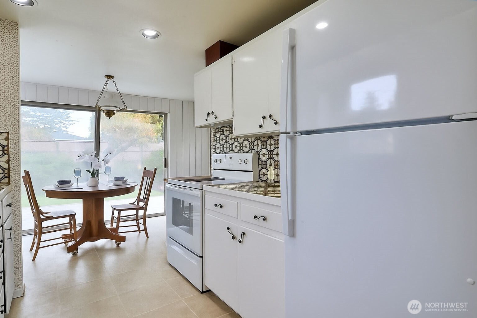 2723 Locust Avenue West University Place, WA 98466 - Photo 8 of 15 a kitchen with white cabinets and window