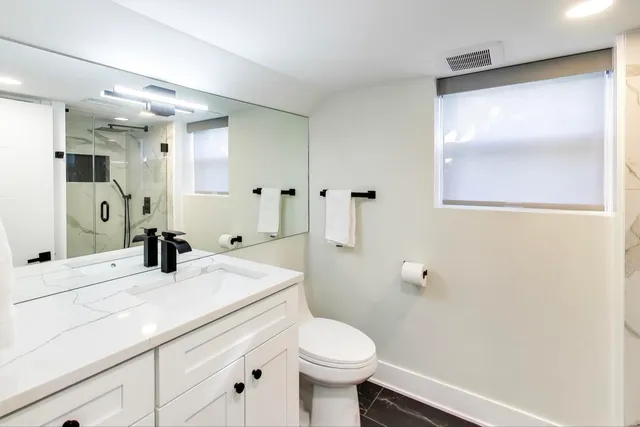 a bedroom with a bed and a large mirror