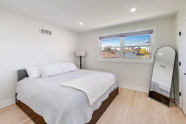 a bedroom with a bed and a mirror