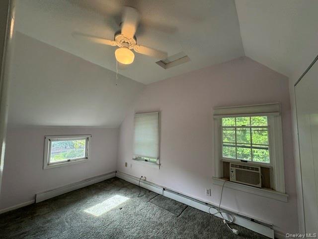 74 South Airmont Road Suffern, NY 10901 - Photo 24 of 42 Room featuring a sloped ceiling, overhead ceiling fan with lighting, two windows, and wall-to-wall carpeting
