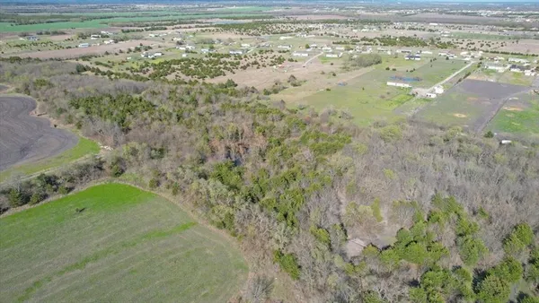 a view of a house with a backyard and a garden
