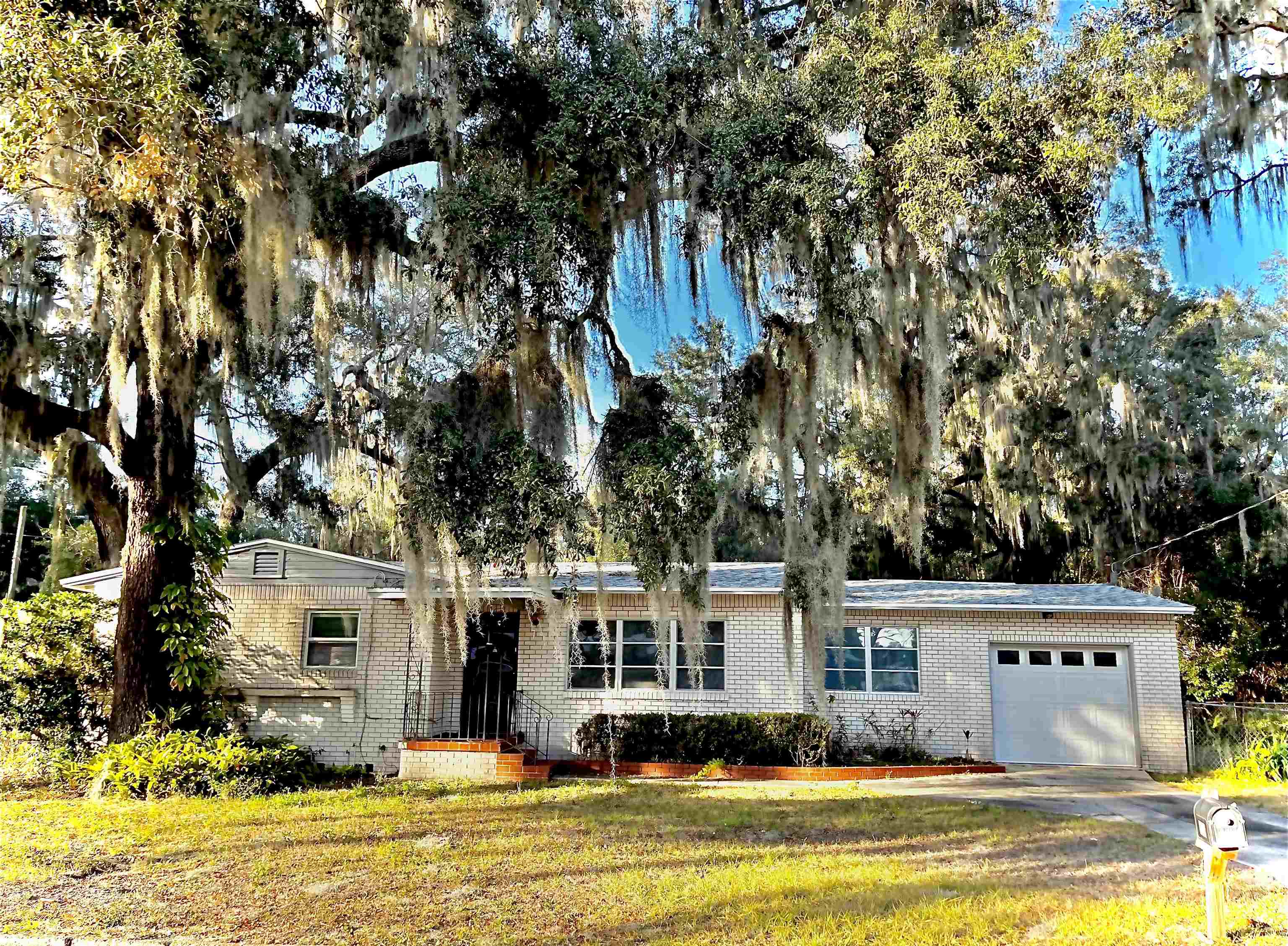 a front view of residential houses with yard and swimming pool