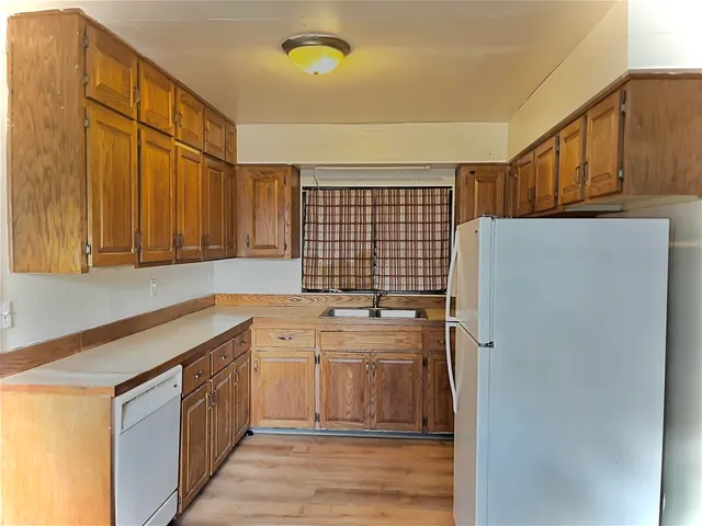 a kitchen with stainless steel appliances a refrigerator sink and cabinets