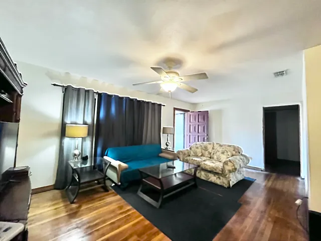 a spacious bedroom with a bed and a chandelier