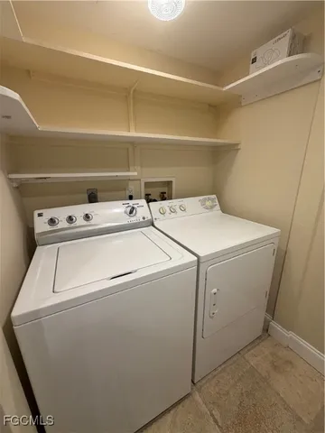 a view of room with a fireplace and window