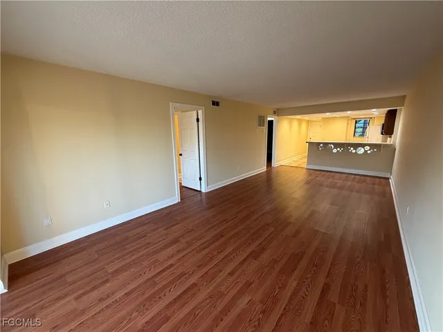 a view of a porch with wooden floor and outdoor seating