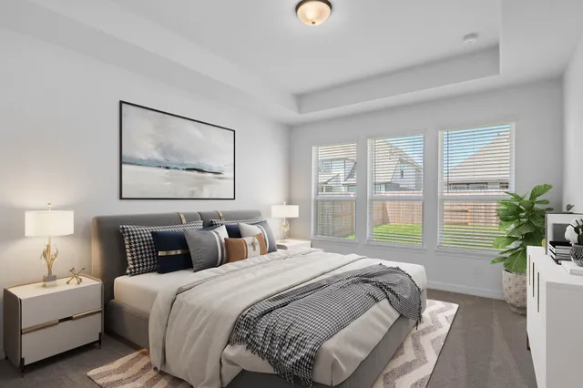 a bedroom with bed and a large window