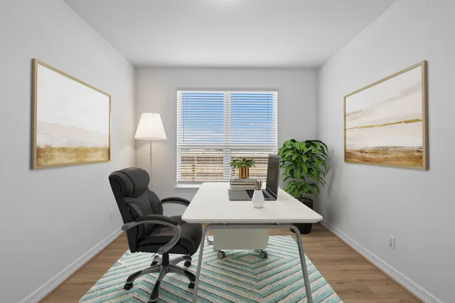 a workspace with furniture and a potted plant
