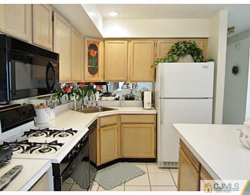 375 Draco Road Piscataway, NJ 08854 - Photo 12 of 25 a kitchen with a sink a stove and a refrigerator