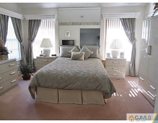 375 Draco Road Piscataway, NJ 08854 - Photo 15 of 25 a bedroom with a bed wooden floor and window