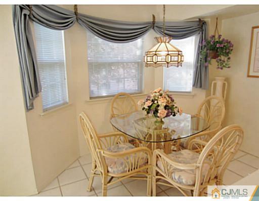 375 Draco Road Piscataway, NJ 08854 - Photo 10 of 25 a view of a dining room with furniture and a chandelier