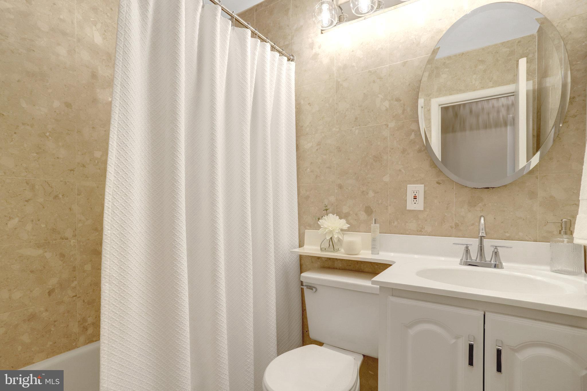 4206 16th Road South Arlington, VA 22204 - Photo 20 of 35 a bathroom with a toilet sink and mirror
