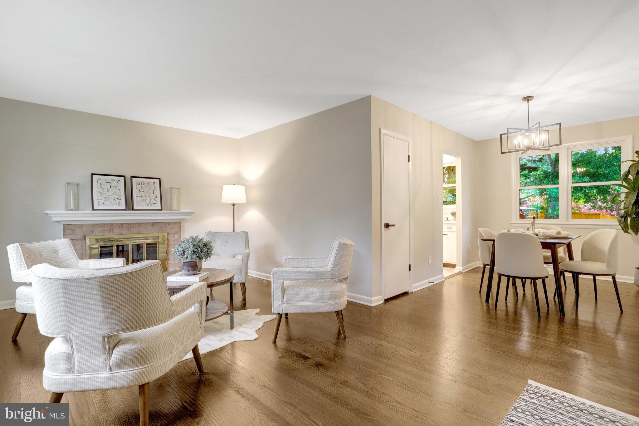 4206 16th Road South Arlington, VA 22204 - Photo 5 of 35 a living room with couches chairs and a dining table with wooden floor